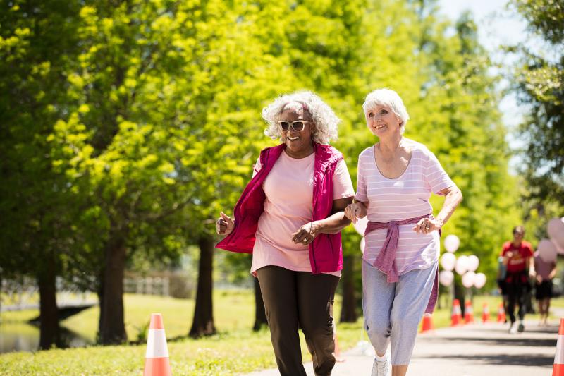 Two elderly women enjoying a walk in the park.