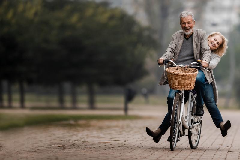 Man and his wife riding a bike after their orthopedic services at Texas Health Huguley Hospital