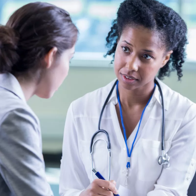 Woman talking to her doctor about getting a mammogram
