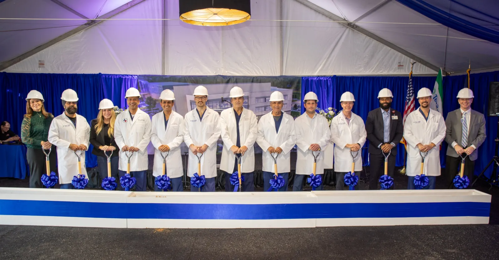 Doctors standing in front of shovels at the groundbreaking event